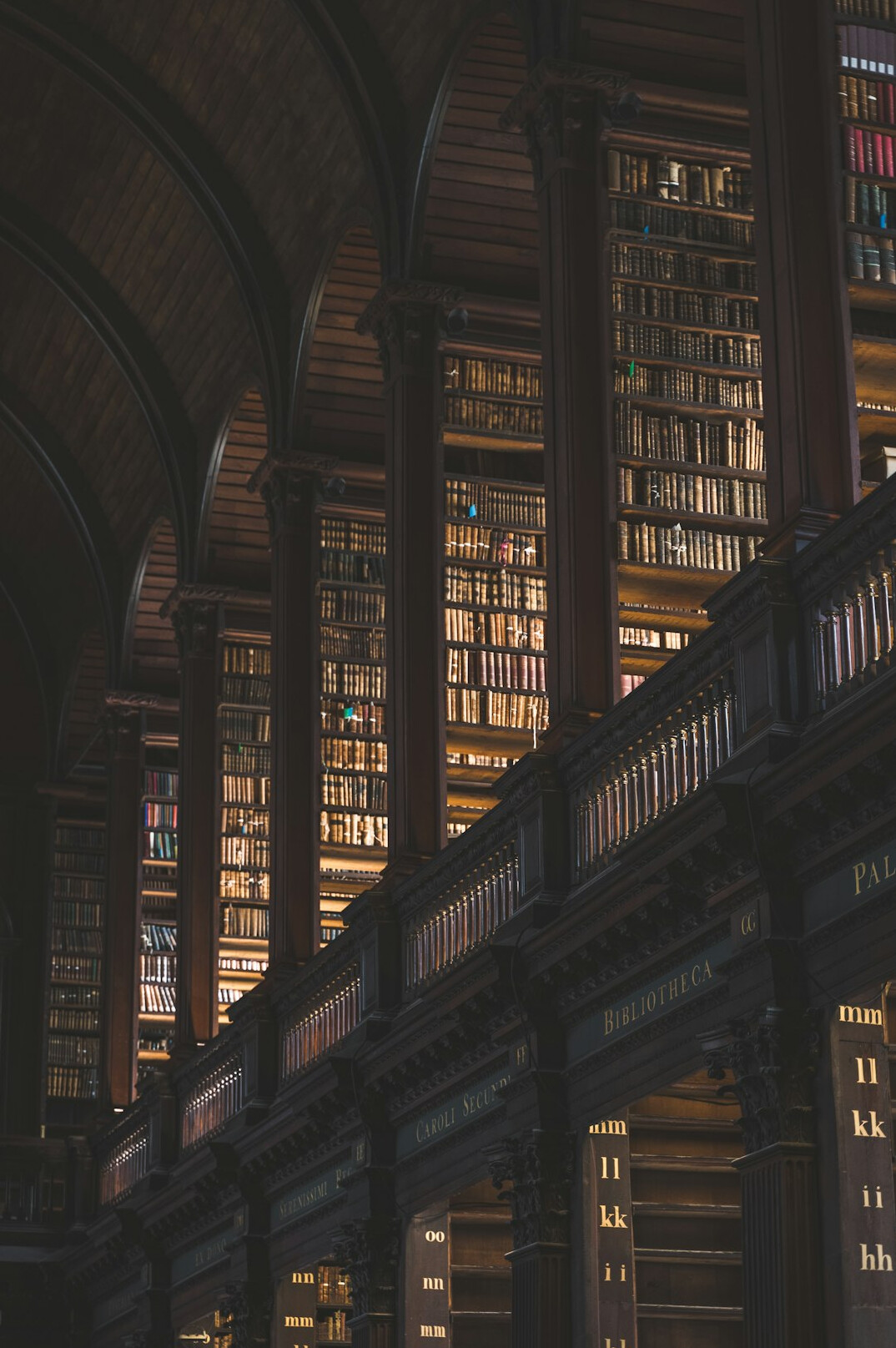 Interior of an old library with tall wooden bookshelves