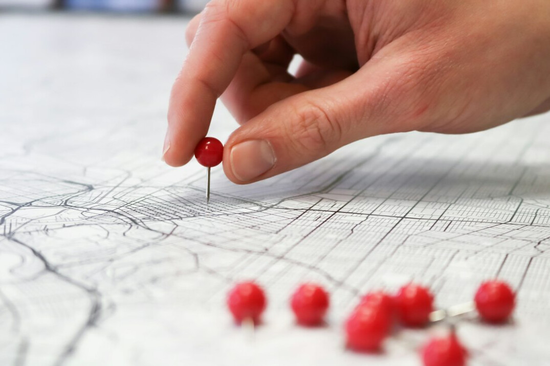 Vintage map with pins and thread on an investigation board
